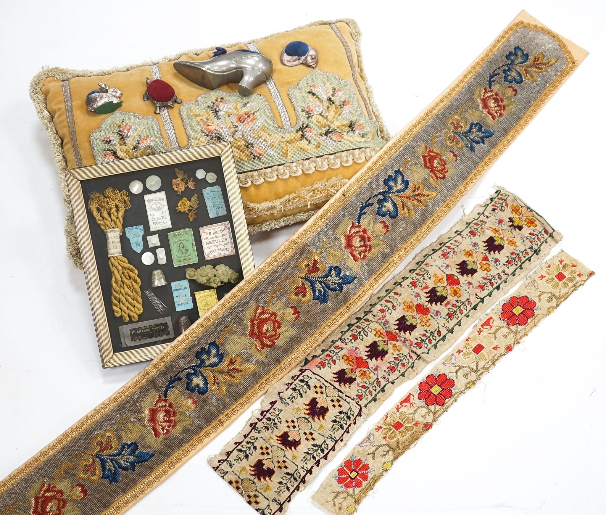 A Berlin bead worked bell pull, a similar cushion, two panels of Turkish embroidery, a framed sewing related collage and four animal pin cushions